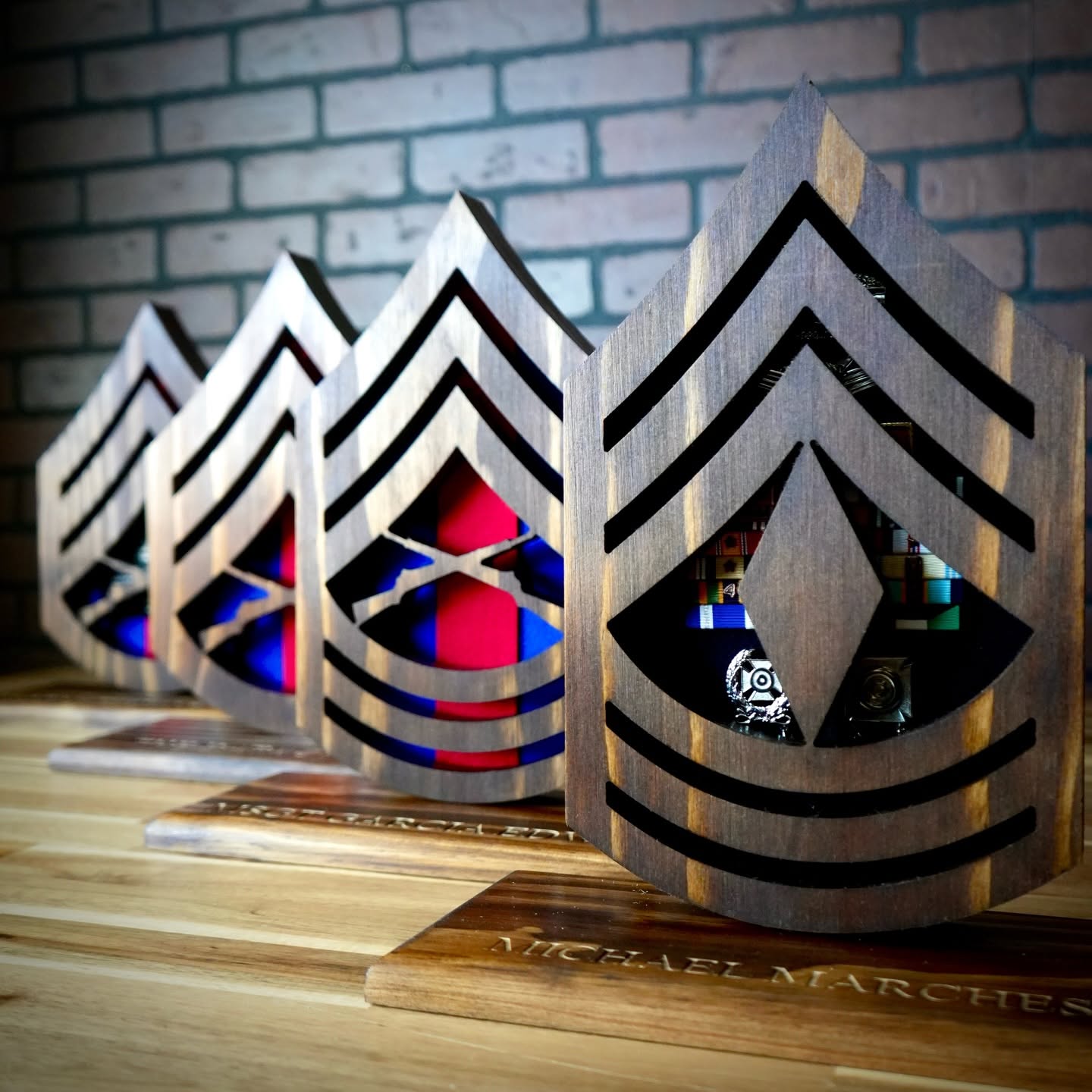 Wood Marine Corps rank desk cases on engraved bases, displaying ribbons and badges