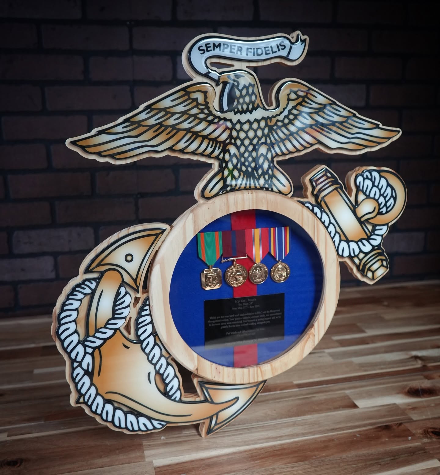 Marine Corps Eagle, Globe, and Anchor wood shadow box displaying medals and a citation plate